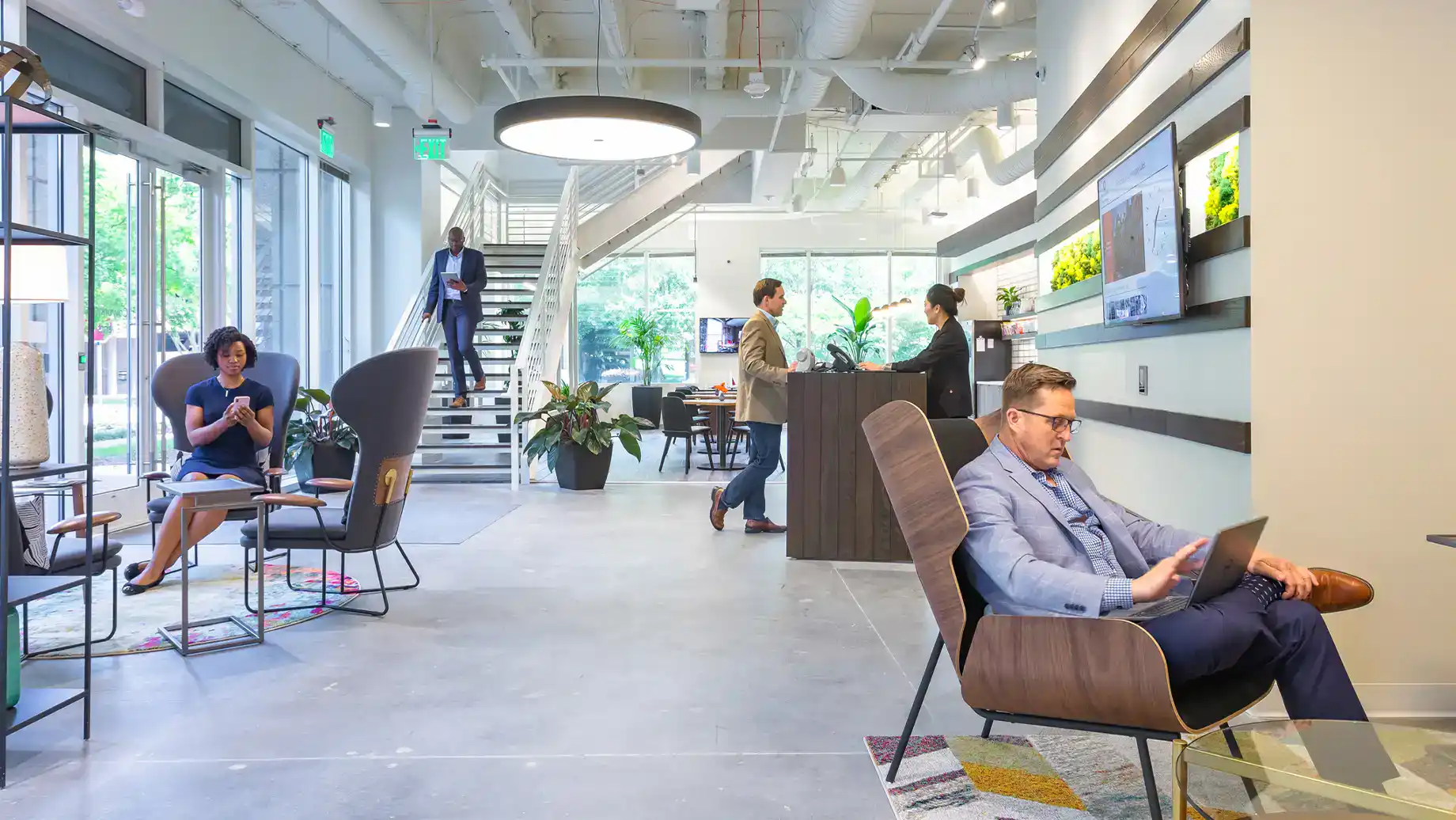 Cumberland Atlanta Private Office & Coworking Space, front desk, members work throughout the Coworking area.